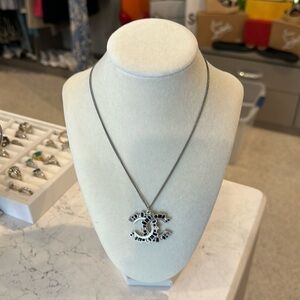 Authentic Chanel silver 16” (extends to 24”) black/clear stones logo necklace